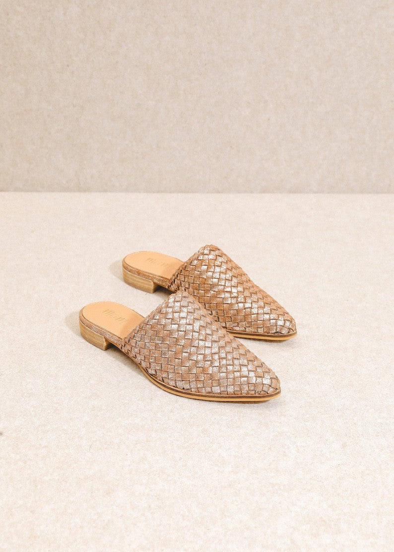 Pair of woven sandals on a light beige background