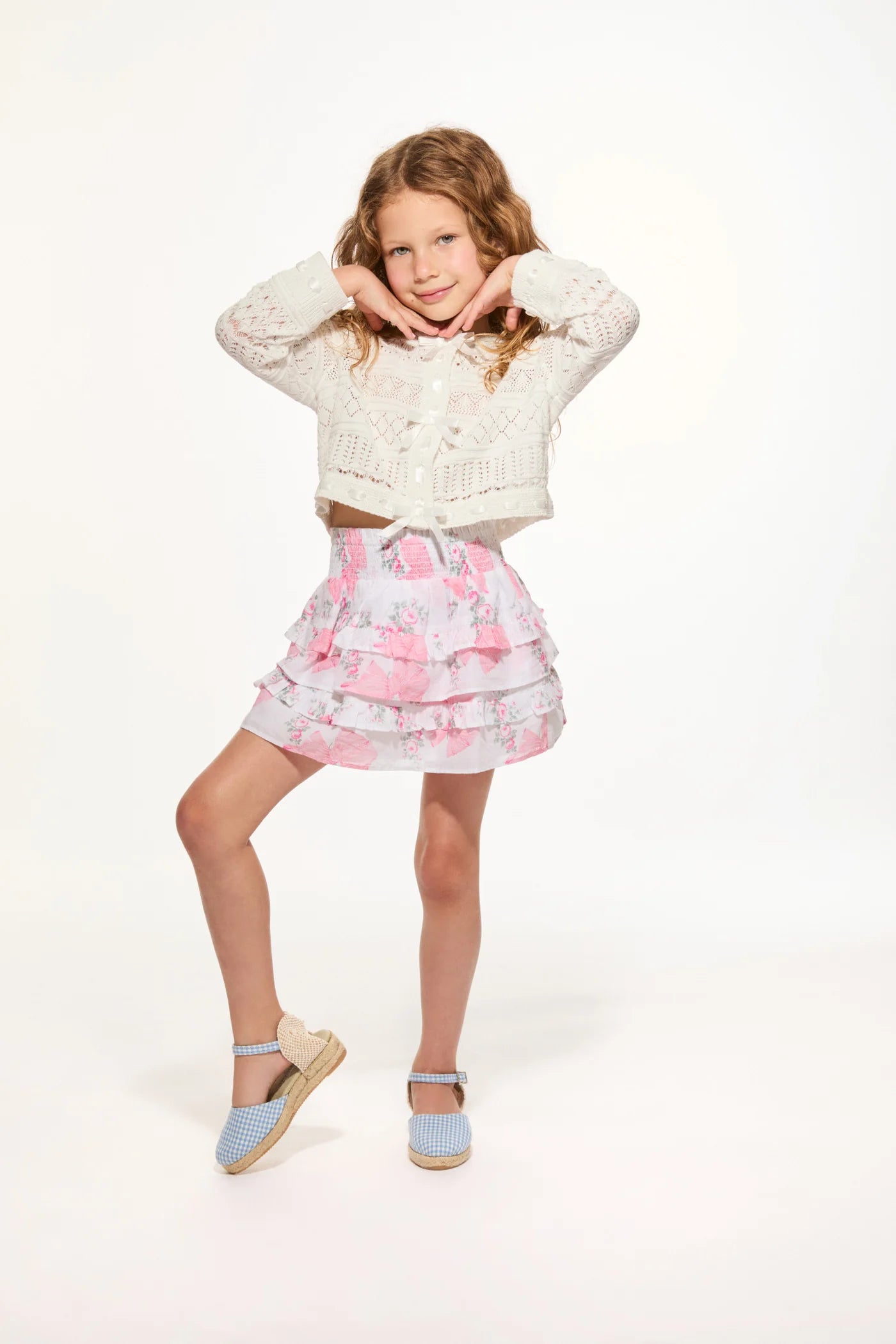 Women sitting in grass field wearing LoveShackFancy Slip Dresses