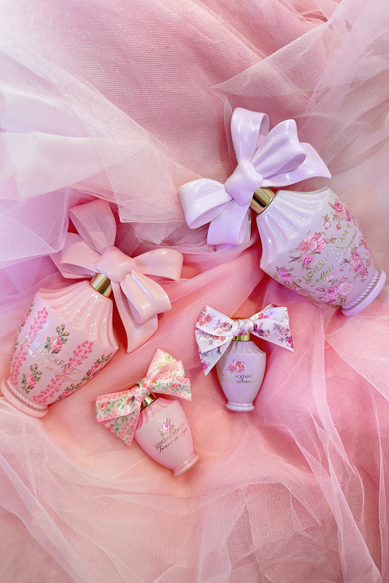 Women sitting in grass field wearing LoveShackFancy Slip Dresses