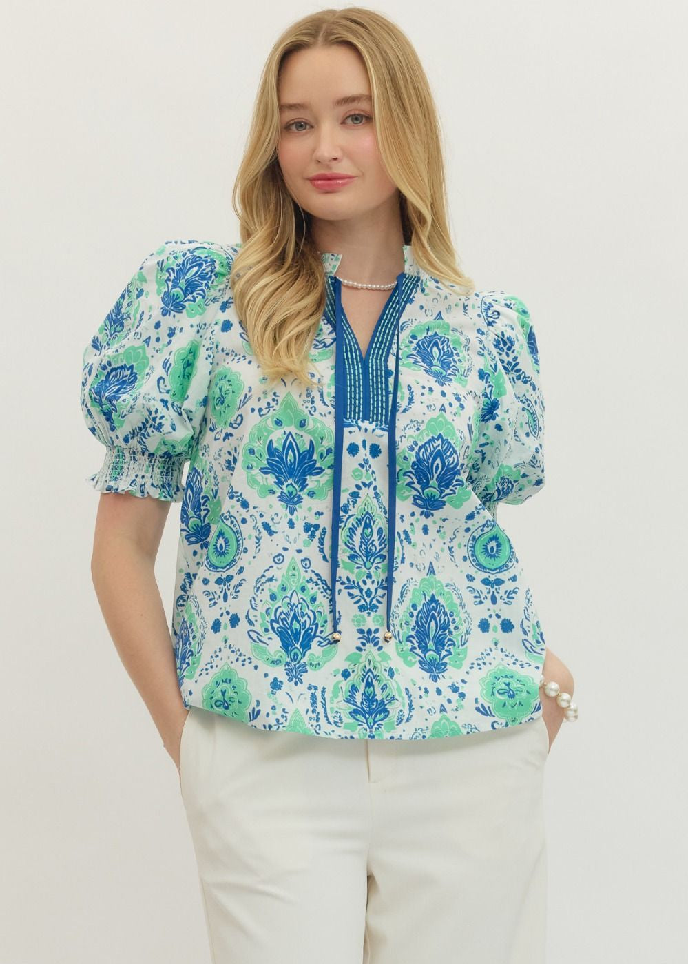 Woman wearing a floral blouse with a white background