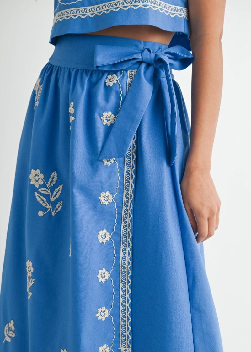 Blue embroidered skirt with a white background