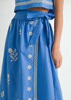 Blue embroidered skirt with a white background