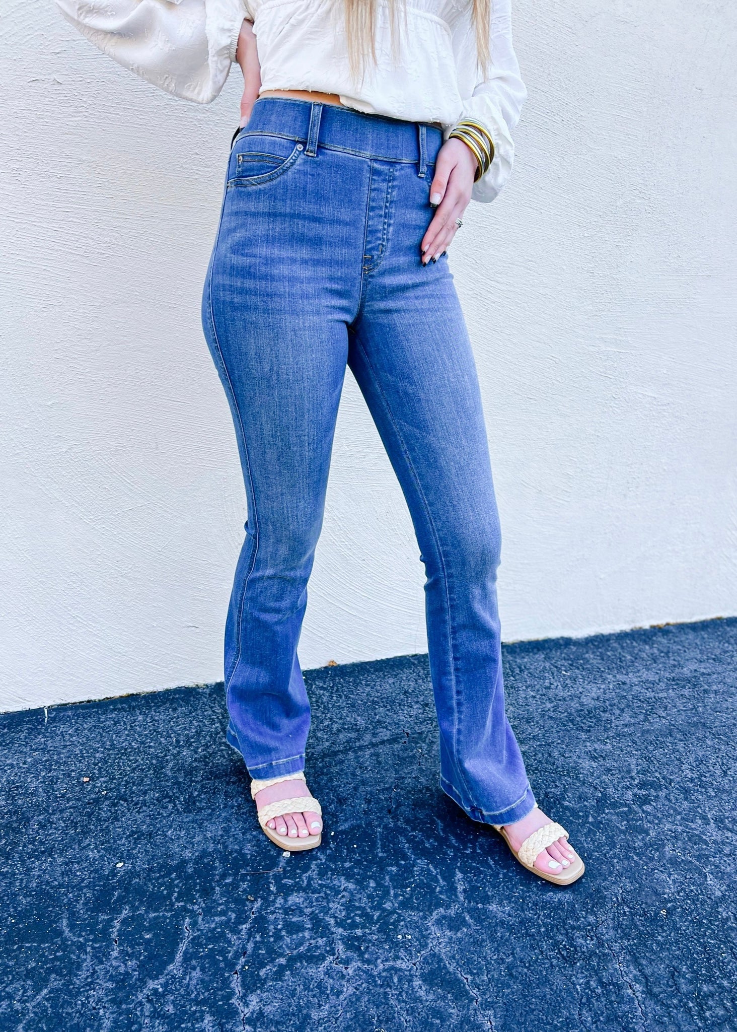 Model is wearing the Spanx flare jeans in Medium Wash, which are designed with premium stretch and are sure to be your next pair of go to denim! This is a full length style and also features a pull on style.