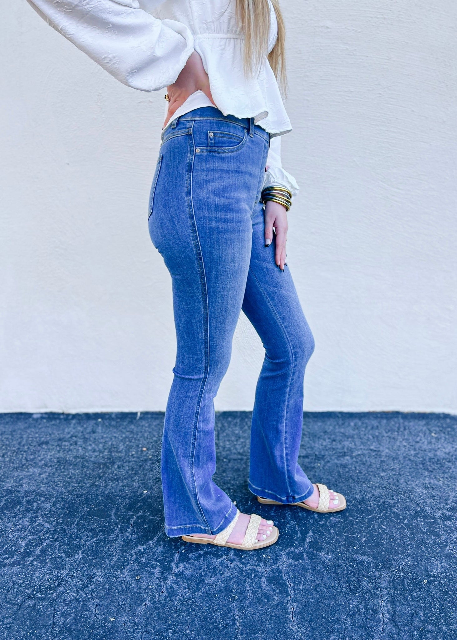 Model is wearing the Spanx flare jeans in Medium Wash, which are designed with premium stretch and are sure to be your next pair of go to denim! This is a full length style and also features a pull on style.