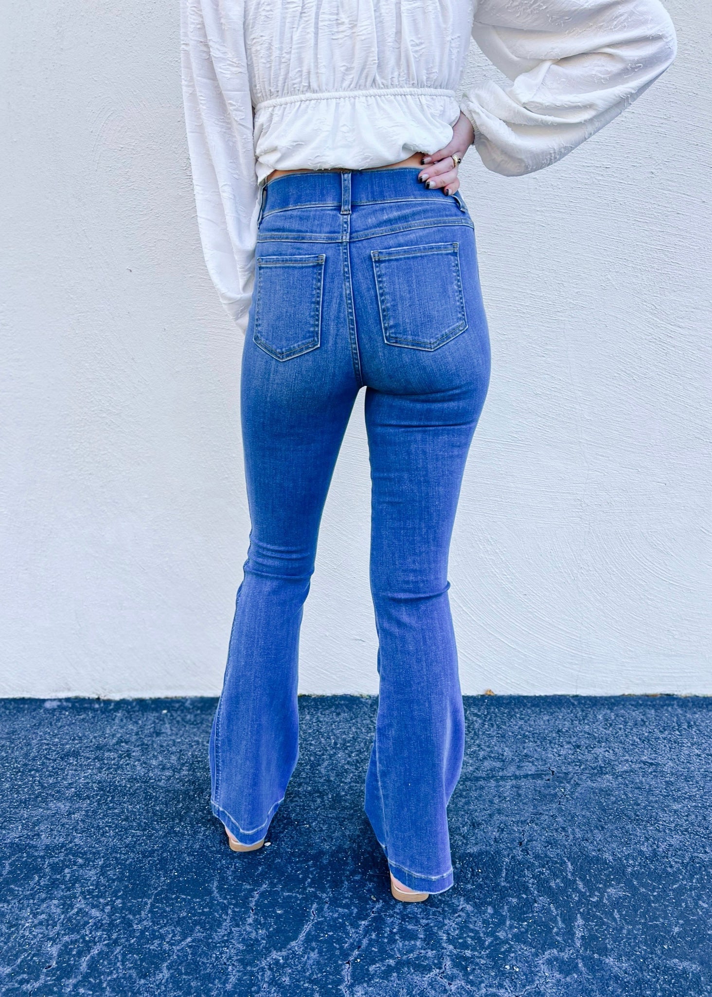 Model is wearing the Spanx flare jeans in Medium Wash, which are designed with premium stretch and are sure to be your next pair of go to denim! This is a full length style and also features a pull on style.